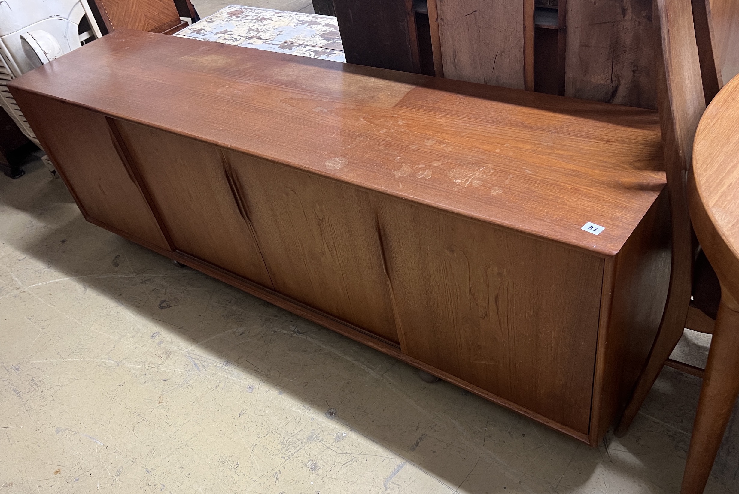 A mid century Danish Mobler teak sideboard (lacking legs), length 200cm, depth 46cm, height 64cm